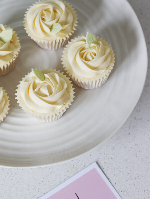 Handmade and decorated vanilla cupcakes with a rose swirl design - the perfect gift sent in the post