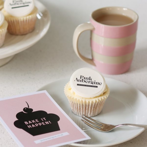 Cupcake on a plate personalised with a printed logo topper on a sugarpaste disc. Pink Cornishware mug and gift card
