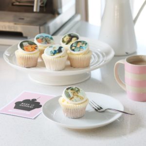 Delicious Cupcakes on a cake stand with personalised photos printed on hand made toppers. Pink Cornishware striped mug and Pink Aubergine Gift Card