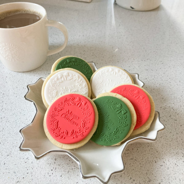 Hand baked shortbread biscuits decorated in red, green and white sugarpaste, embossed with Merry Christmas