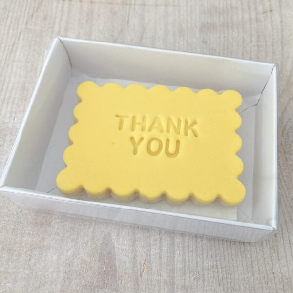 Rectangular shortbread biscuit embossed with Thank You sent in the post in gift packaging