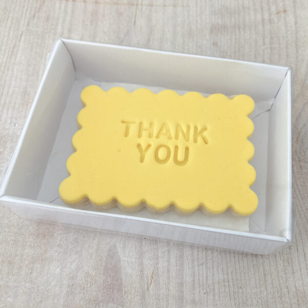 Rectangular shortbread biscuit embossed with Thank You sent in the post in gift packaging