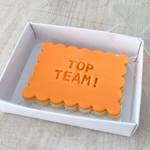 Rectangular shortbread biscuit embossed with Top Team sent in the post in gift packaging