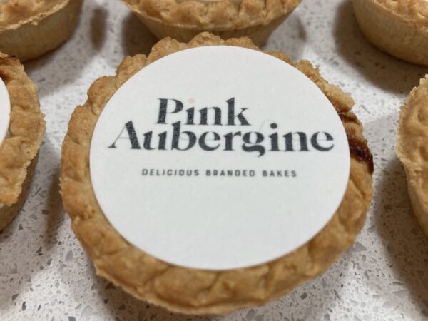 Mince pie decorated with a Pink Aubergine Branded Bakes printed logo for a Corporate Gift or treat for Christmas parties and presents