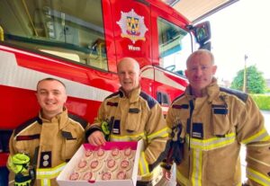 Firefighters enjoying their logo gift cupcakes - Pink Aubergine Branded BAkes